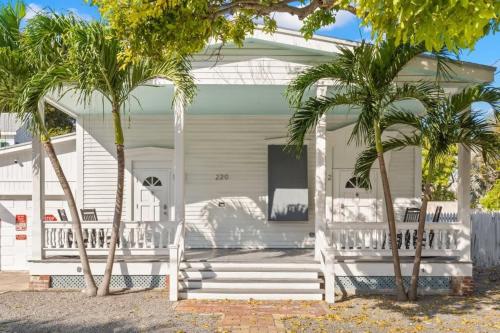 a white house with palm trees in front of it at Mesa House, Dos -Unreal Location in Key West