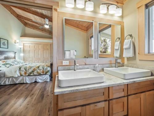 two sinks in a bathroom with a bed at South Kona Farm House on 22 Acres in Milolii in Papa Bay Estates