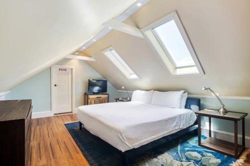 a bedroom with a bed and two skylights at Sky Loft in Key West by Brightwild in Key West