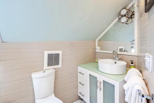a bathroom with a toilet and a sink at Sky Loft in Key West by Brightwild in Key West