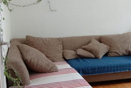 a couch with pillows on it in a room at Private Rooms in Hannover