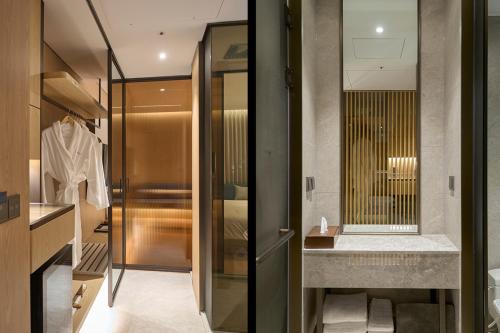 a bathroom with a walk in shower and a sink at Mayfield Hotel Seoul in Seoul