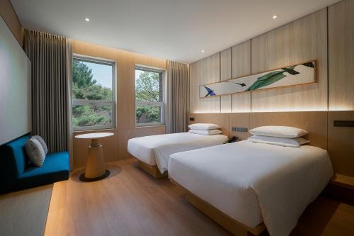 a hotel room with two beds and a window at Mayfield Hotel Seoul in Seoul