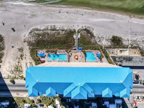 an overhead view of a blue building at the beach at 8th Floor Gulf View Beachfront Condominium by Brightwild in Panama City Beach
