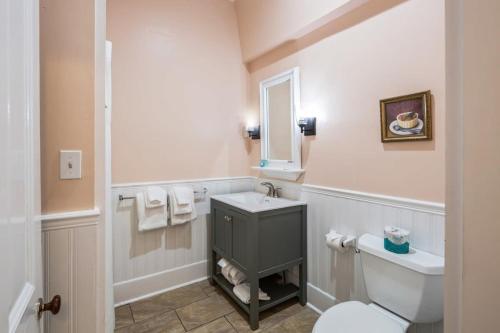 a bathroom with a toilet and a sink at Creme Brulee Suite by Brightwild in Key West