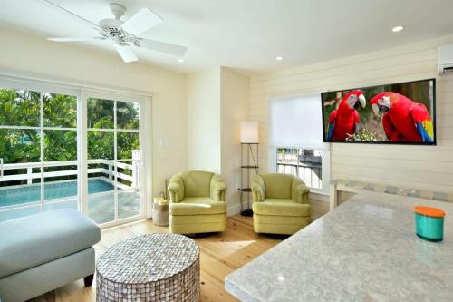 a living room with two parrots on the wall at Keys Please! in Key West