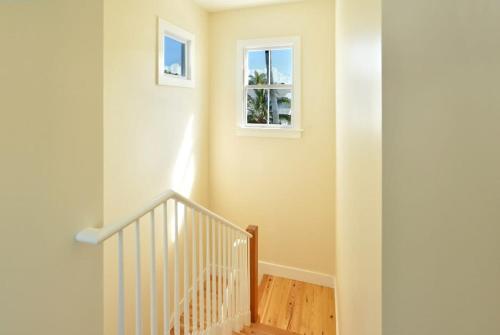 a staircase in a home with a window at Keys Please! in Key West