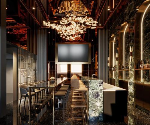 a dining room with a table and chairs and a chandelier at CUBE Social at Boat Quay in Singapore