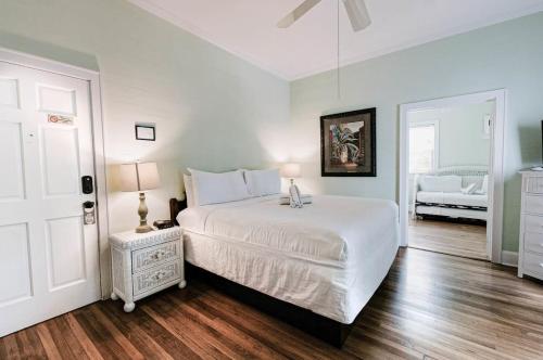 a bedroom with a white bed and a white door at King Suite Balcony by Brightwild- at James House in Key West