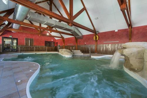 an indoor pool with a water slide in a building at Domaine de Pyrène in Cauterets