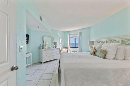 a bedroom with a large bed and a bathroom at Ocean Front Penthouse with Incredible Views! Sunglow Resort 1003 by Brightwild in Daytona Beach Shores