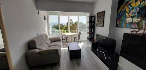 a living room with a couch and a table at Siesta Mar Apartamentos Ibiza in Santa Eularia des Riu