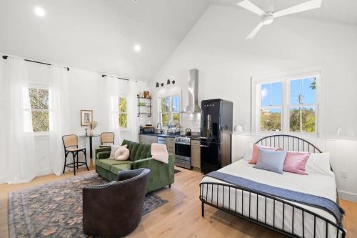 a bedroom with a bed and a living room at Casa Julieta - Stunning Ybor Studio in Tampa