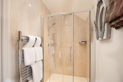 a bathroom with a shower with white towels at Eildon View in Melrose