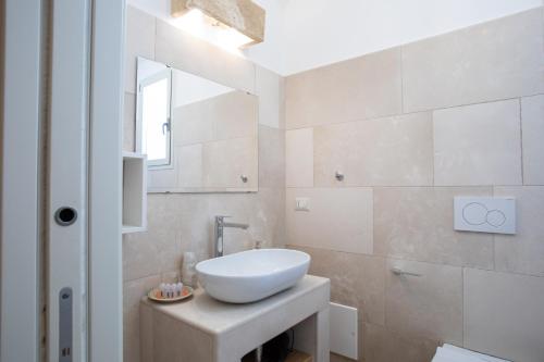 a bathroom with a white sink and a mirror at Il Torrino B&B in Sannicola