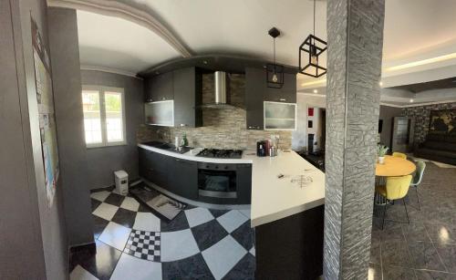 a kitchen with a black and white checkered floor at Villa con Jacuzzi in Ponte Galeria