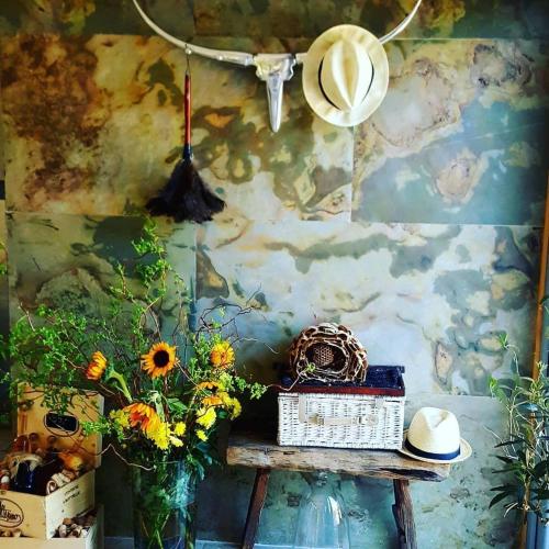 a room with a table with flowers and a hat at 7 STODOŁA - Hotel butikowy in Osiek