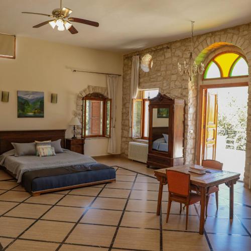 a bedroom with a bed and a table in it at Abdelli Terraces in Batroun in Batroûn