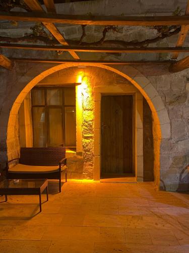 an archway in a stone building with a door at Seven Rock Cave Hotel in Goreme
