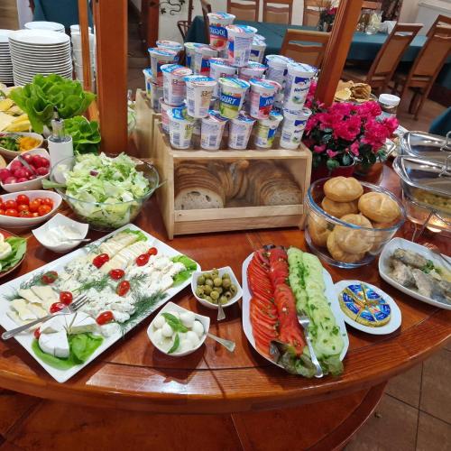 a table with a bunch of food on it at Hotel i Restauracja Nad Jeziorem in Człuchów
