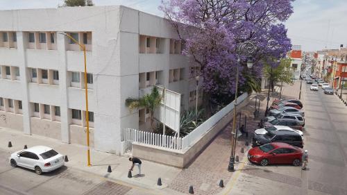 a building with cars parked in a parking lot at Aguascalientes feria nacional de San Marcos in Aguascalientes