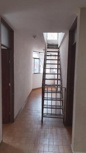 a staircase in an empty room with a stair case at Aguascalientes feria nacional de San Marcos in Aguascalientes