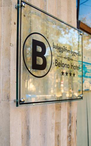 a sign for a hotel on the side of a building at Belona Hotel in Kutaisi