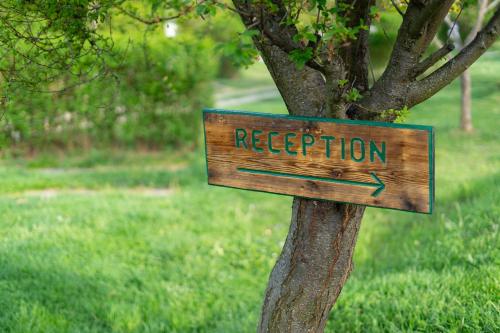 a wooden sign that reads registration attached to a tree at Glamping Cisnadioara in Cisnadioara