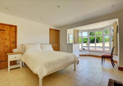 a bedroom with a bed and a desk and a window at Dentford Heights in Beetley