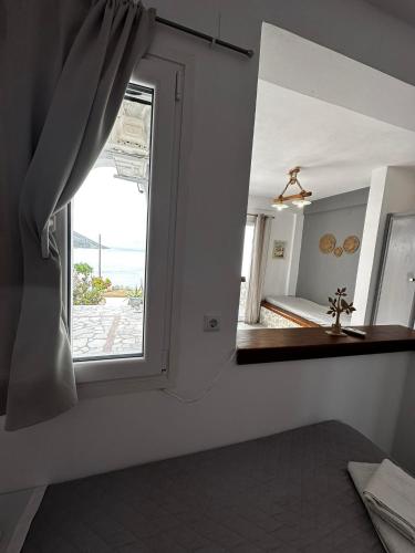 a room with a window and a mirror at Elenis Studios&Apartments in Masouri
