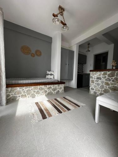 a living room with a couch and a fireplace at Elenis Studios&Apartments in Masouri