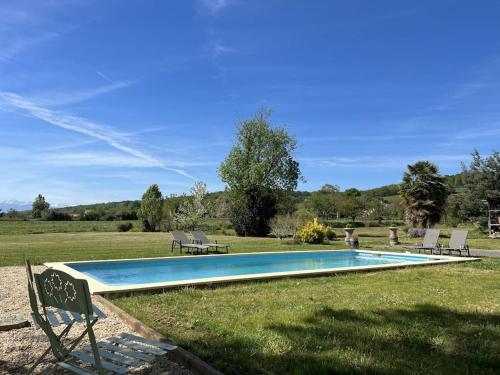 a swimming pool in the middle of a field at Villa Nid d'Oiseaux in Lustar
