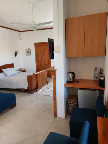 a living room with a bed and a desk and a kitchen at Abdelli Terraces in Batroun in Batroûn