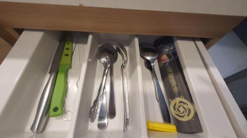 a group of utensils in a drawer at Vanilla One Residence Apartment Batam in Batam Center