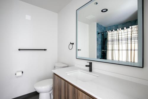 a white bathroom with a sink and a mirror at Blueground West Loop gym roof nr Union Park CHI-1050 in Chicago