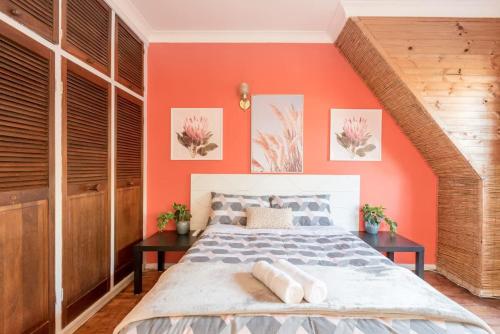 a bedroom with an orange wall and a bed at Private Room in Sans Souci Guesthouse in Sydney