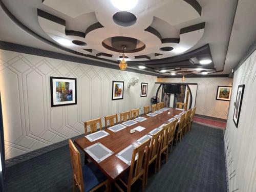 a conference room with a long table and chairs at Signature Skardu Hotel in Skardu