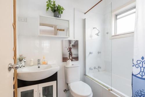 a bathroom with a sink and a toilet and a shower at Private Ensuite Queen room near Sydney Airport in Sydney