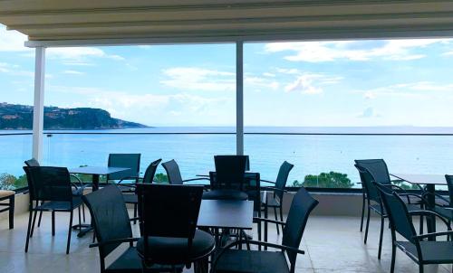 a restaurant with tables and chairs and a view of the water at Mateo in Himare