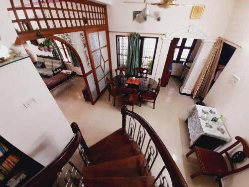 an overhead view of a living room with stairs and chairs at Unwind @ Serene Retreat in Palakkad
