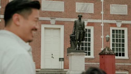 a man standing in front of a statue in front of a building at Loews Philadelphia Hotel in Philadelphia