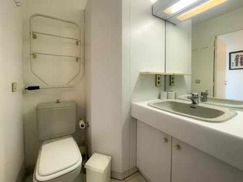 a white bathroom with a toilet and a sink at Port Vauban Sea Front 3 Pers AC WiFi in Antibes