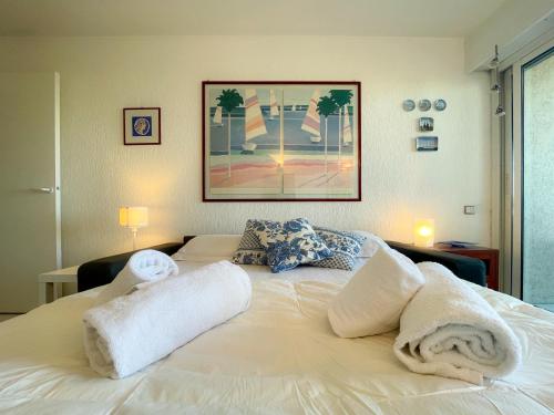 a bedroom with a white bed with towels on it at Port Vauban Sea Front 3 Pers AC WiFi in Antibes