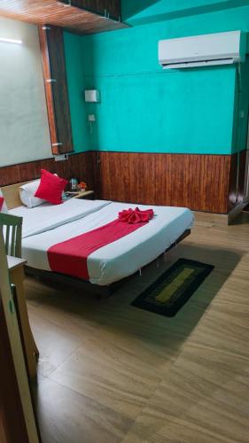 um quarto com uma cama com almofadas vermelhas em PRANJAL INN HOTEL em Patna
