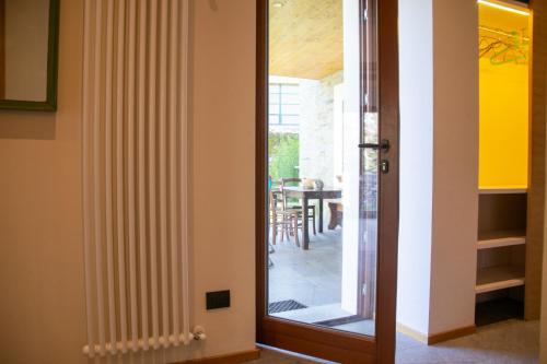 a door leading to a dining room with a table at Casa Cassiopea - WelcHome in Cannobio