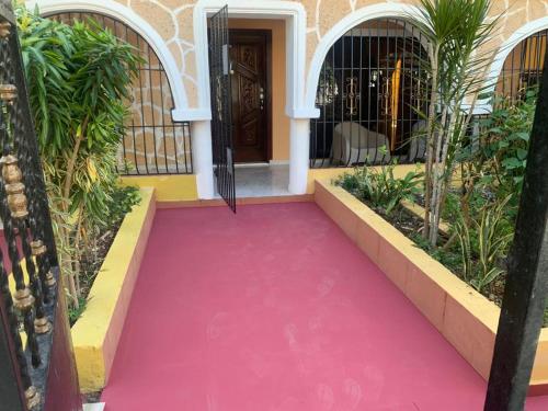 a pink carpeted walkway in front of a house at Casa Francesca in Boca Chica