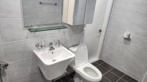 a bathroom with a toilet and a sink at 2room with 4beds near kintex daehwa station in Goyang