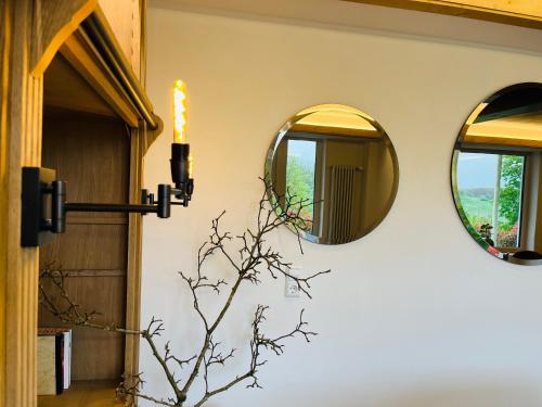 a room with two mirrors on the wall at Hotel Schlossberg in Badenweiler