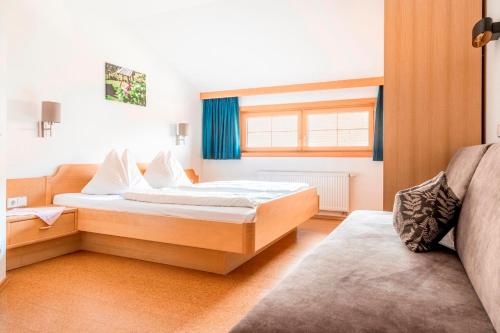 a bedroom with a bed and a window at Prechtlhof in Flachau in Flachau