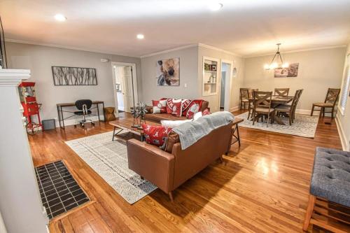 a living room with a couch and a table at Sweet Home Alabama Sleeps 8 in Tuscaloosa